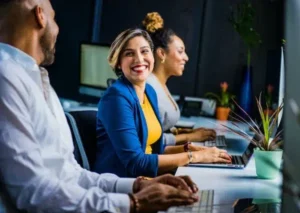 smiling woman sitting at desk